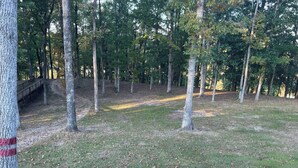A park with a wooden bench and a metal fence. - Redfish at Eufaula, AL (Eufaula)