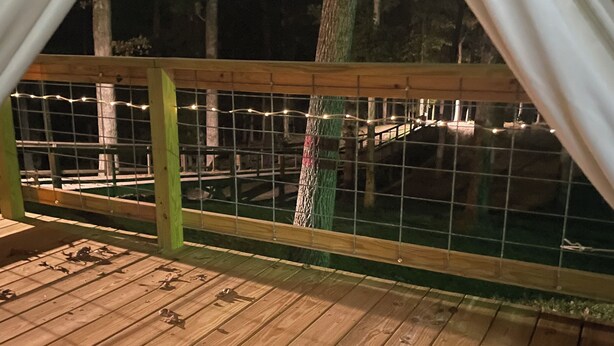 A wooden deck with a wire fence, surrounded by trees. - Redfish at Eufaula, AL (Eufaula)