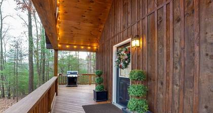 A charming cottage surrounded by woods, with your own private hot tub and outdoor fire pit, perfect for relaxing and enjoying the nature around you.