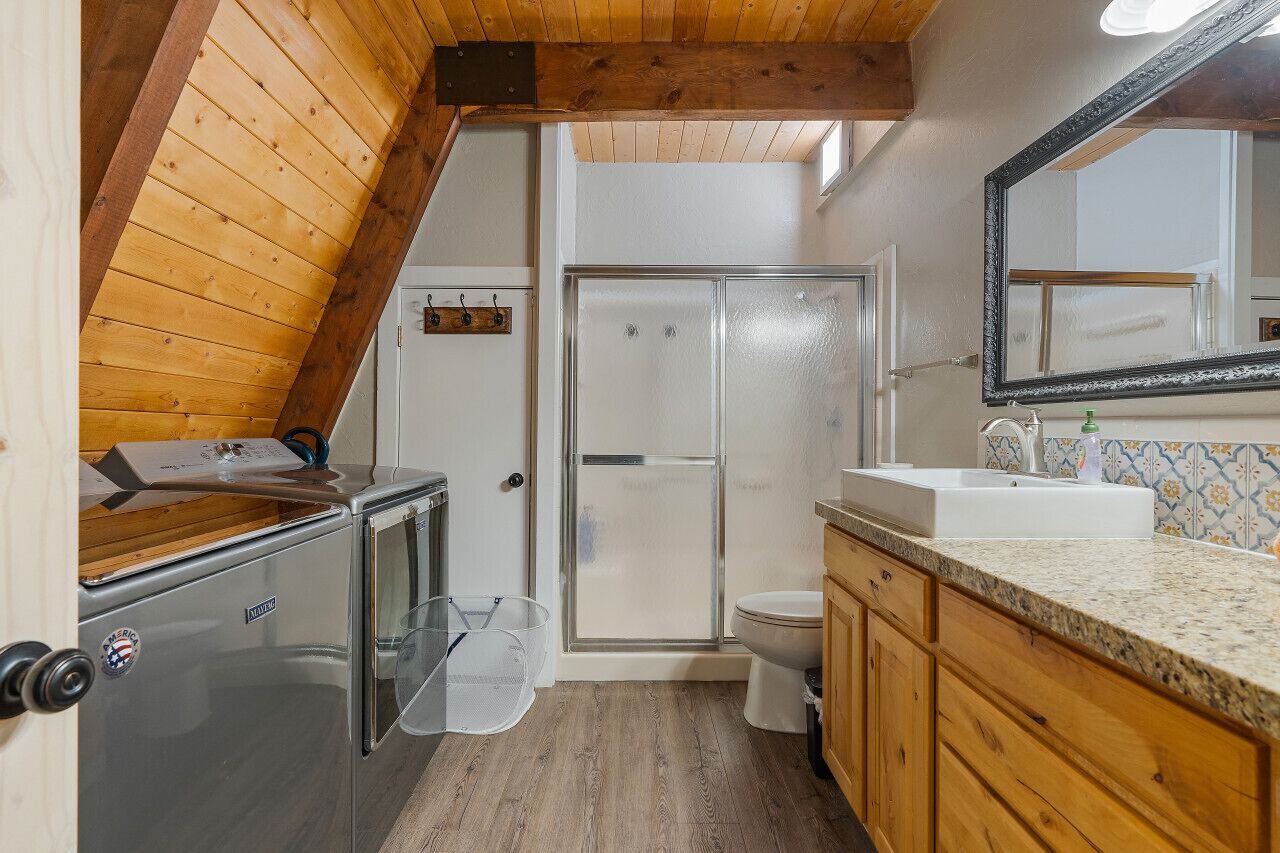 A compact bathroom with a shower, toilet, and sink.