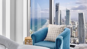 A high-rise room with a large window overlooking a city skyline and a beach. - Oceanfront Escape! 2 Beds Home w/ Gym  & Carpark (Surfers Paradise)