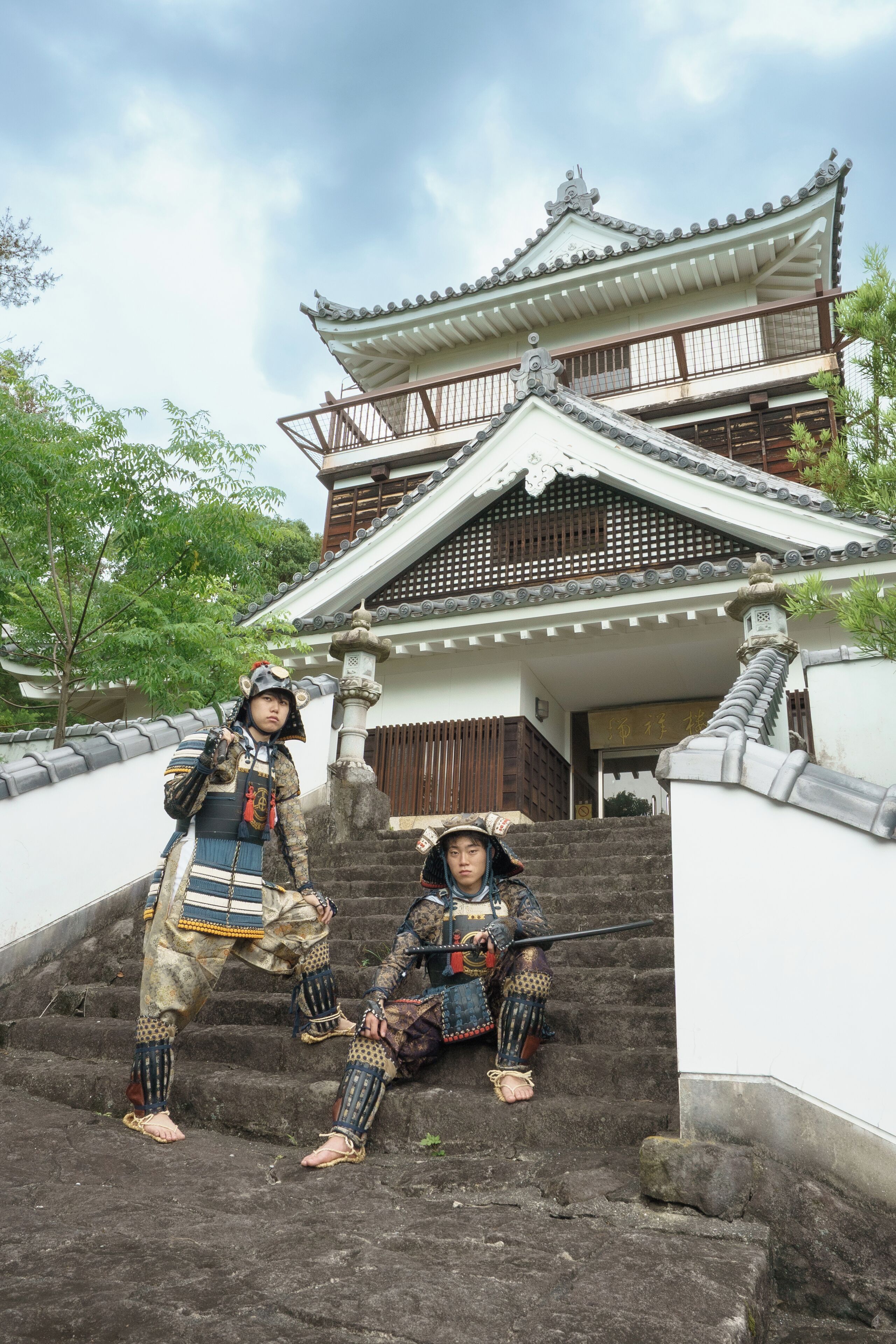 A traditional Japanese building with a multi-tiered roof and wooden railings.