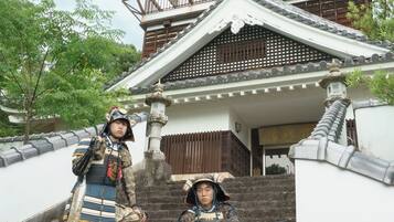 A traditional Japanese building with a multi-tiered roof and wooden railings.