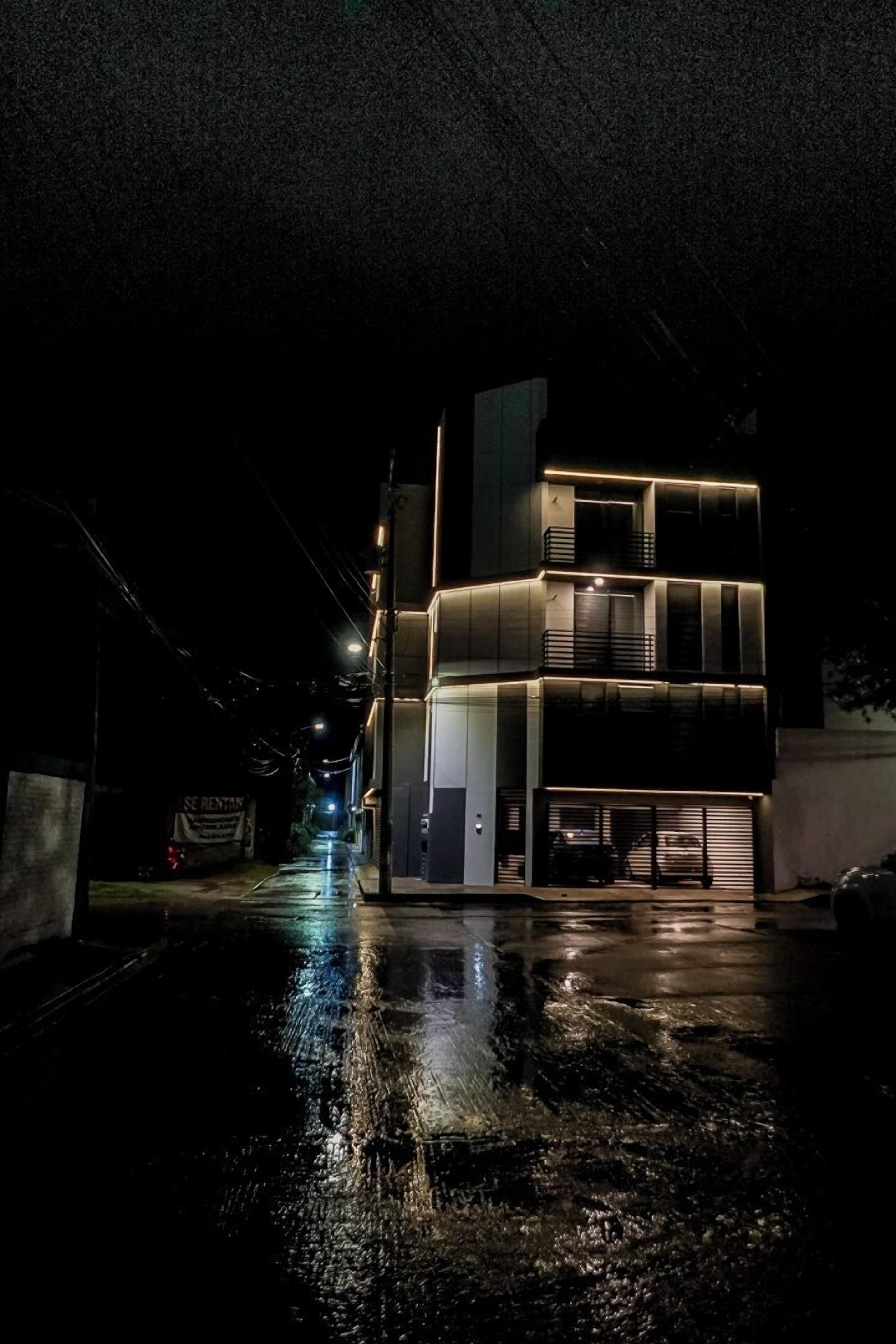 Vista frontal de la propiedad por la tarde o noche