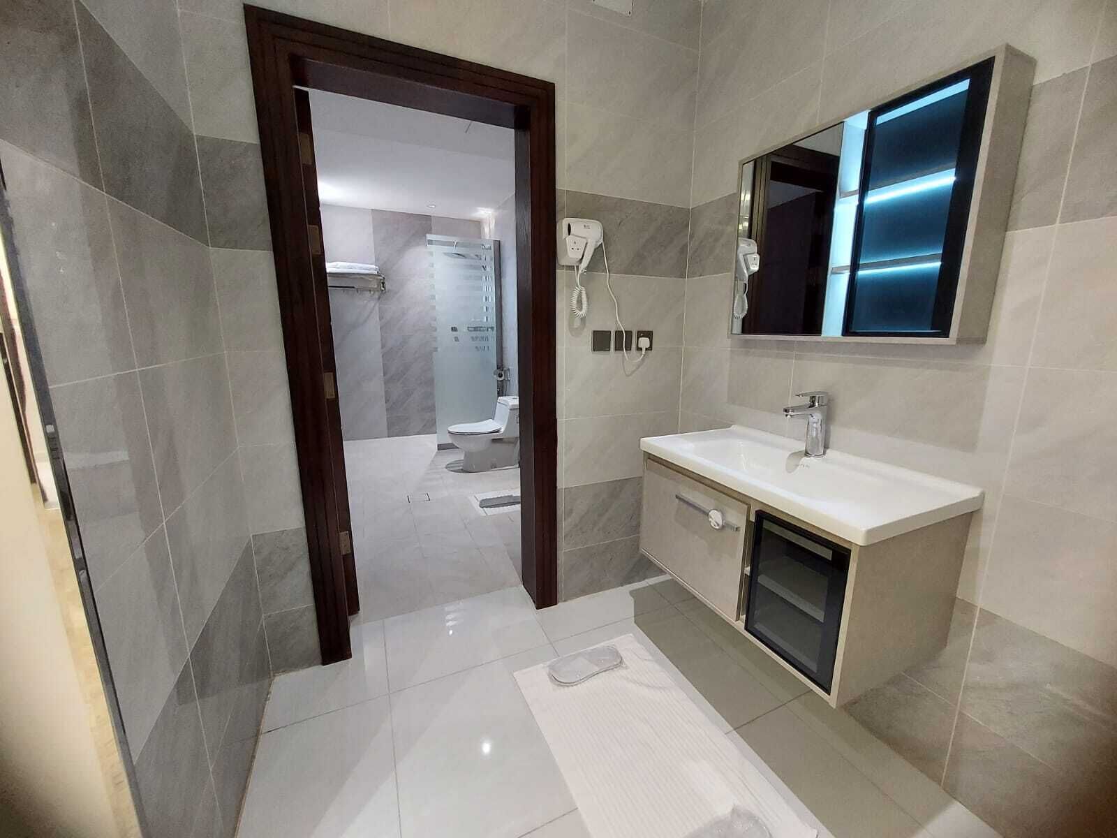 Shower, rainfall showerhead, designer toiletries, hair dryer