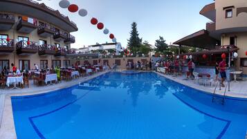 Relax by the pool surrounded by comfortable seating and take in the views from the hotel's curved balcony.
