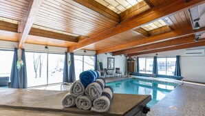 A pool area with wooden beams, a pool table, and towels. - Historic home w/ indoor pool on Iconic 8th St (Fargo)