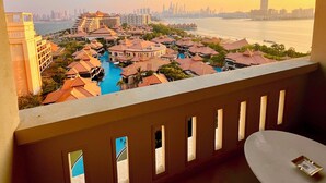 A resort with a swimming pool, multiple buildings, and a view of the city skyline. - Palm Jumeirah, Studio, Fantastic sea, beach and skyline view, Beach  (Dubai)