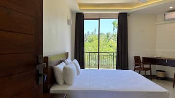 Habitación doble Deluxe, varias camas, balcón, vista a la ciudad | Muebles diferentes, escritorio y tabla de planchar con plancha