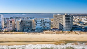 A coastal hotel complex with multiple high-rise buildings, a sandy beach, and a view of the sea. - HPN-Stunning 2 Bedroom Direct Ocean Front Condo (Ocean City)