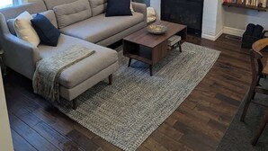 A living room with a sectional sofa, a coffee table, a fireplace, and a bookshelf. - Park-Side Home in Jamaica Plain (Boston)