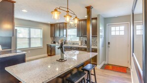 A modern kitchen with granite countertops, stainless steel appliances, and a central island with bar stools. - 5 Mi to Lake: Port Clinton Home w/ Gazebo & Grill! (Port Clinton)
