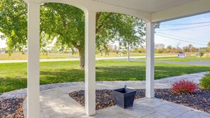 A covered porch with a view of a grassy area and a road. - 5 Mi to Lake: Port Clinton Home w/ Gazebo & Grill! (Port Clinton)