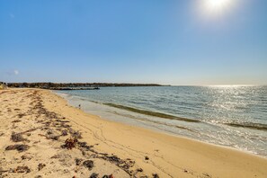 A beach with a clear sky and calm sea. - 4 Mi to Beach: Furnished Deck at Waterford Home! (Waterford)
