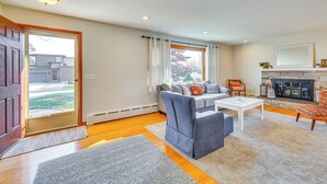 A living room with a sofa, coffee table, and fireplace.