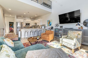 A modern living room with a sofa, armchairs, a coffee table, and a TV. - < 2 Mi to Dtwn Reno: Luxe Midtown Gem w/ Patio (Reno)