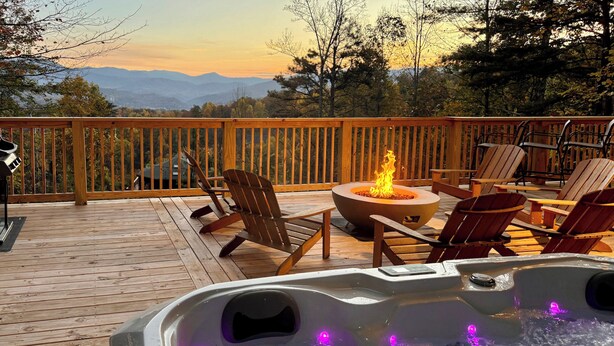 A wooden deck with a hot tub, chairs, and a fire pit. - 3 Mi to Dtwn: Mtn-view Cabin in Gatlinburg! (Gatlinburg)