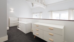 A room with a white dresser, a mirror, and a window with curtains. - Host Stay City Hall View (Sheffield)