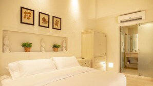 A bedroom with a large bed, a nightstand, a dresser, and a mirror. There are three framed pictures on the wall above the bed. - w Fantastic House w Amazing Pool in Cartagena (Cartagena)