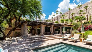 A pool area with lounge chairs, a pergola, and a view of mountains. - LUX - Historic Tennis Club Enclave - King Beds (Palm Springs)
