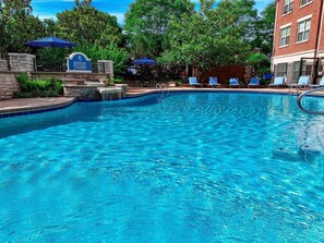 A swimming pool with lounge chairs and a sign reading "Stetson Square". - Landing | Spectacular 1BD, Pool, Gym (Cincinnati)