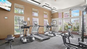 A fitness center with treadmills, elliptical machines, and a stationary bike. - Landing | Modern 2BD, Pool, Gym (Jenks)
