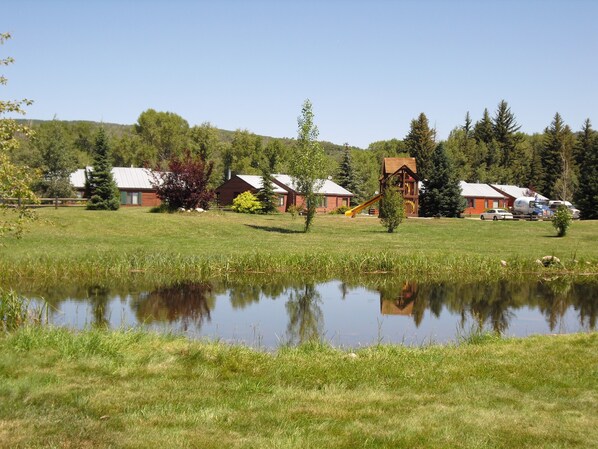 A lakeside property with cabins, a playground, and a pond. - Juniper - Get away with modern conveniences (Clark)
