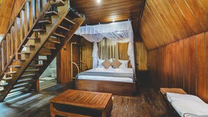 A wooden cabin with a bed, a bench, and a staircase. - River View Villa (Dharga Town)
