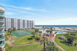 A hotel with a tennis court, pool, and ocean view. - Gulf Shores Plantation-Palms 6511 (Gulf Shores)