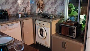 A compact kitchen with a washing machine, a toaster, and a sink. - Lovely loft in the heart of Casablanca  (Casablanca)