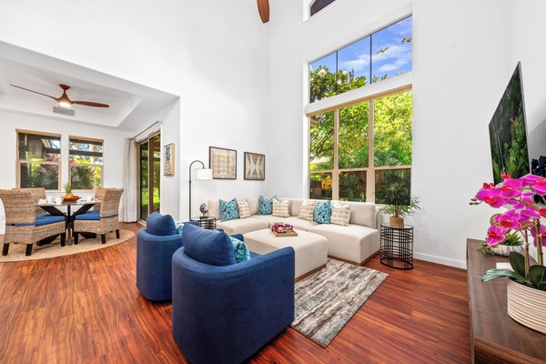 Spacious living room with vaulted ceilings and tall windows