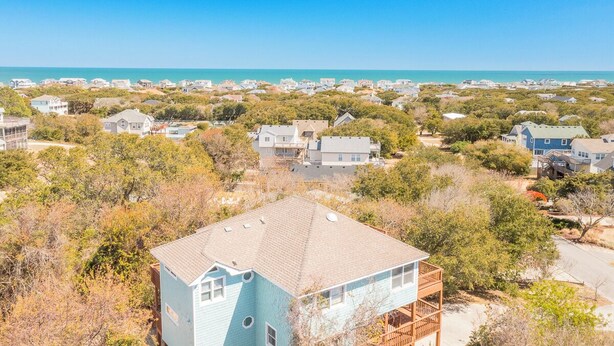 A coastal residential area with houses and a view of the ocean.