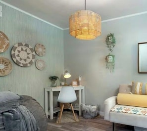 A room with a bed, a desk, a chair, and a hanging light fixture. - Boho Mtn Vibe'z~ Hot Tub+Fire Pit~ 3 mins to BRP! (Spruce Pine)