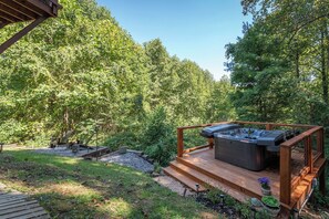 A hot tub on a wooden deck surrounded by a forest. - Boho Mtn Vibe'z~ Hot Tub+Fire Pit~ 3 mins to BRP! (Spruce Pine)