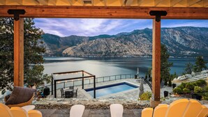 A pool area with a view of mountains and a lake. - NEW! Gorgeous lake home w/ private pool, hot tub, lake access with dock & views! (Manson)