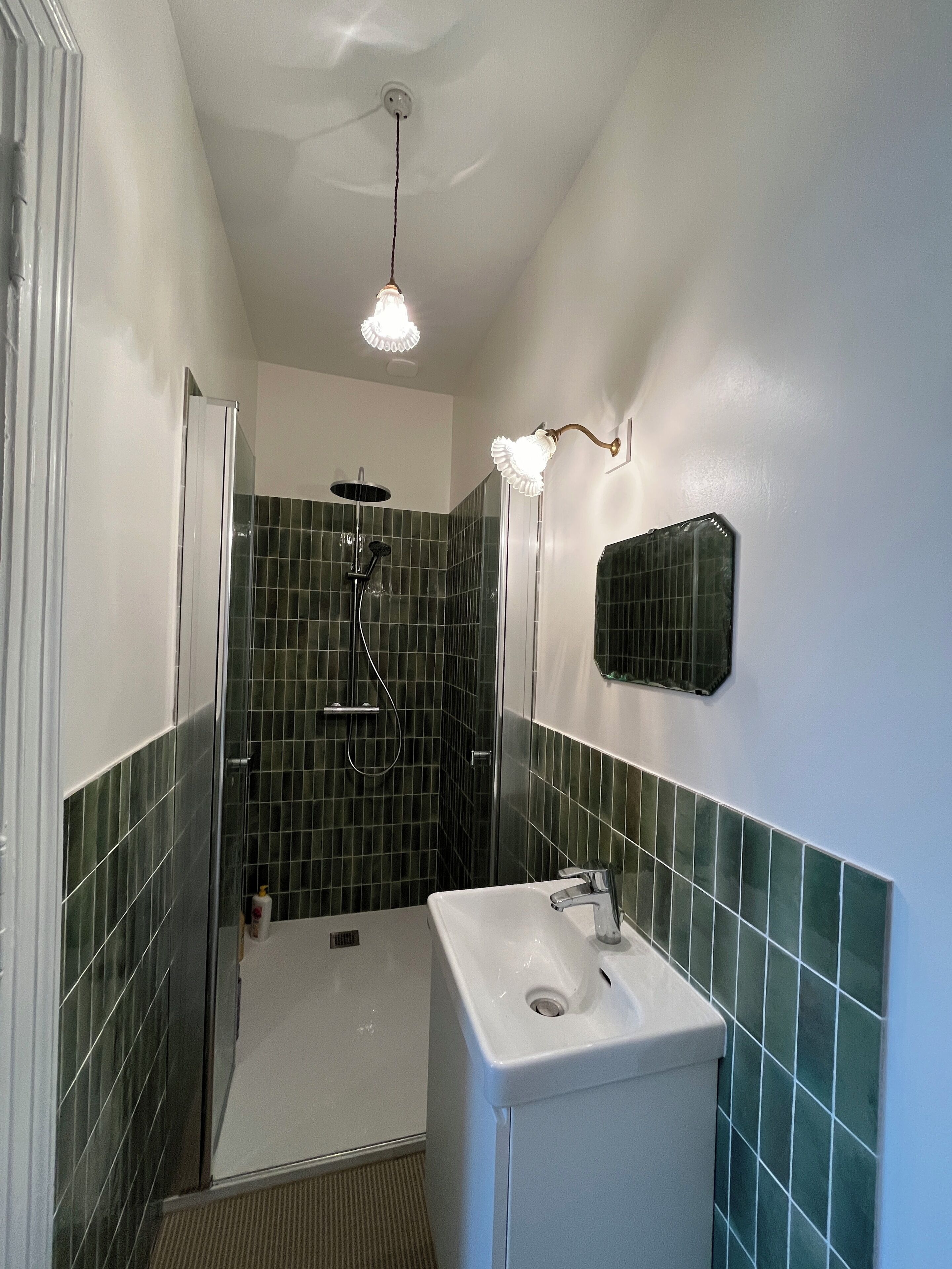 A bathroom with a shower, a sink, and a toilet.