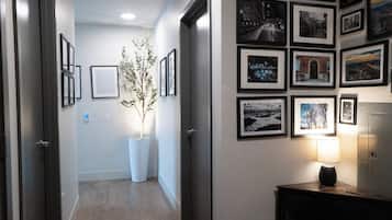 Stunning hallway with framed photographs, a potted plant, and a cozy reading nook.