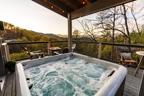 A hot tub on a wooden deck with a view of trees and hills. - Stunning View | Game Room Fun | Hot Tub & Fire Pit (Sevierville)