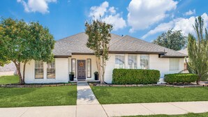 A single-story house with a front entrance, a covered porch, and a well-maintained lawn. - Modern & Spacious 3BD/2BA Luxury in Central Frisco (Frisco)