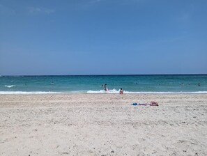 On the beach, sun loungers, beach towels