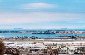 A coastal cityscape with a prominent airport, including runways and a parked aircraft. - Hillside Oasis with Jacuzzi, Ocean Views, BBQ, Treetop Master, EV Charger (San Diego)