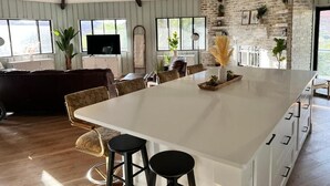 A spacious kitchen with a large island, wooden flooring, and a high ceiling with exposed beams. - 2 Acre  Retreat, Sauna, Fire pit, Decks, Views, 35 Min to Zion, 45 GC, 45-Bryce (Kanab)