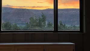 A window with a view of a sunset over a mountainous landscape. - 2 Acre  Retreat, Sauna, Fire pit, Decks, Views, 35 Min to Zion, 45 GC, 45-Bryce (Kanab)