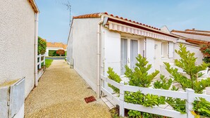A narrow gravel path leading to a row of white buildings with red-tiled roofs. - 1 bedroom awesome home in Vaux-sur-Mer (Vaux-sur-Mer)