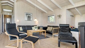 A modern interior with a wooden ceiling, a sofa set, a dining table, and a kitchen area. - Stunning home in Ringkøbing with sauna (Ringk øbing)