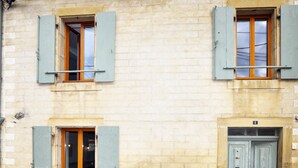 A building with three windows, each with blue shutters and wooden frames. - 3 bedroom pet friendly home in Castelreng (Castelreng)