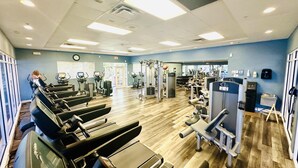A gym with treadmills, weight machines, and exercise balls. - Beautiful Condo at Reunion (Kissimmee)
