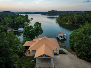 A house with a dock extending into a lake, surrounded by trees. - 900ft of water frontage: Private Spacious Luxury Waterfront Point @ Smith Lake! (Bremen)