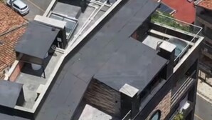 A multi-story building with a rooftop terrace, air conditioning units, and a parking area. - LINVING 35 8TH FLOOR VIP (Medellín)