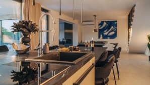 A modern kitchen with a central island, stainless steel appliances, and pendant lighting. - Beautiful home in Privlaka with sauna (Privlaka)